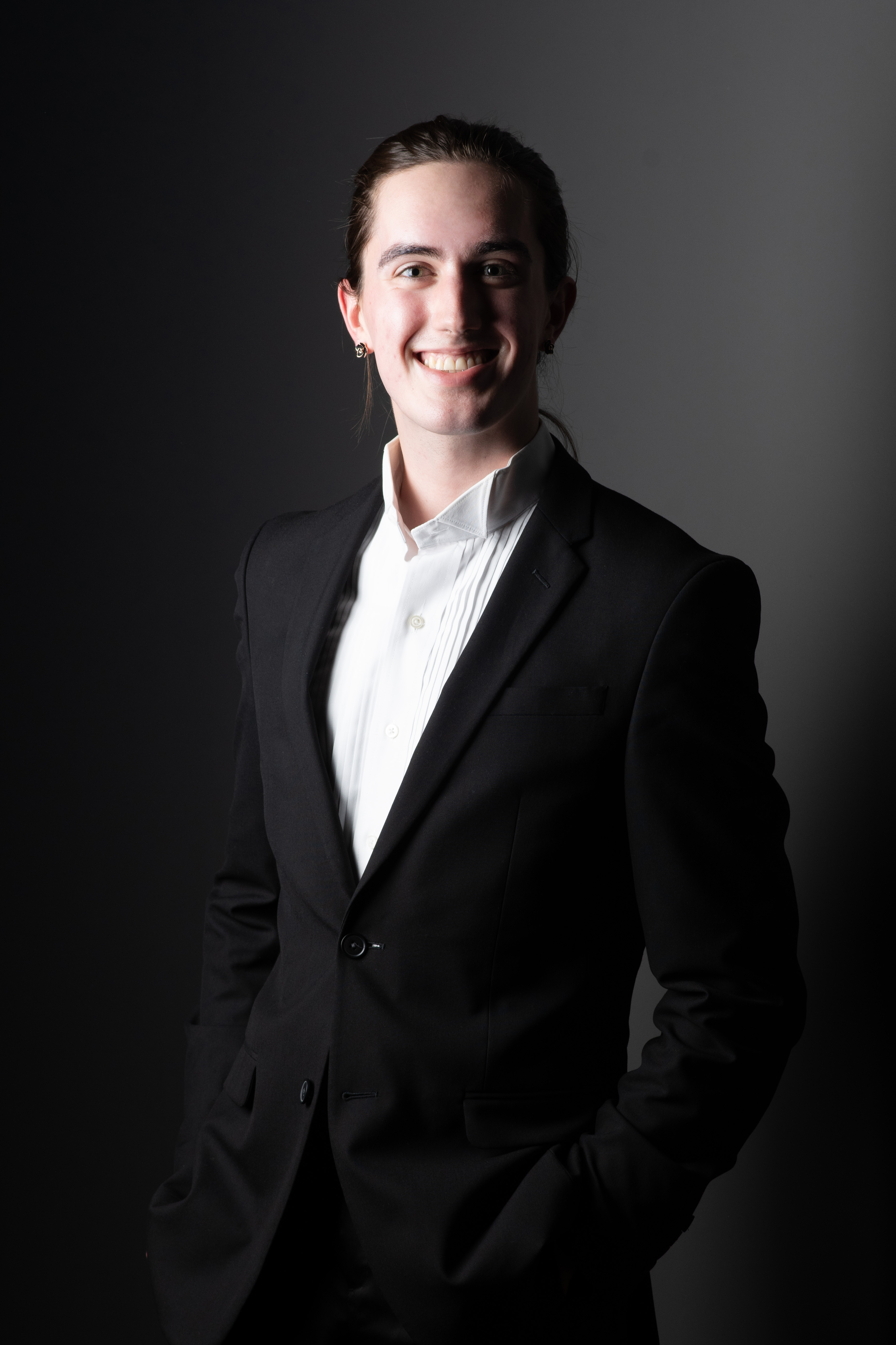 A headshot of Zac Harmon in a tuxedo.